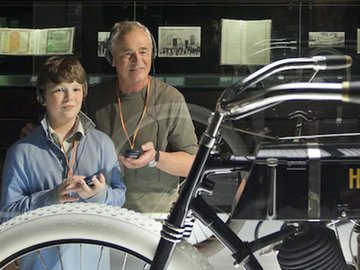 Man and young man taking the audio tour