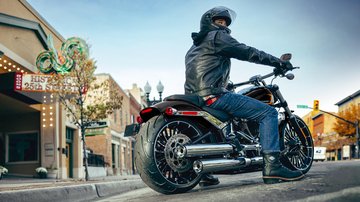 rider sits on bike near curb 